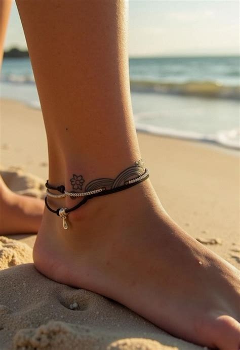 This Anklet Tattoo Beautifully Mimics The Grace Of Jewellery The Beaded Chain Design With A Dangling Pendant Symbolizes Femininity And Beauty And The Red Colour Shows Passion And Protection Do You Want